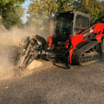 skid steer with road saw cutting conrete