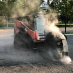 skid steer road saw cutting asphalt