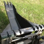 heavily gusseted skid steer stump bucket