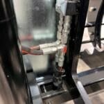 grapple rake with protected hose routing