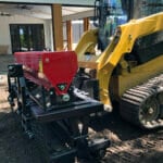 seeder planting by a house