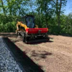 skid steer with seeder in field
