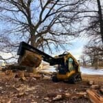 picking up log with skid steer splitter