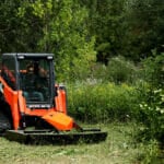 skid steer brush mower in the field