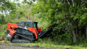 skid loader brush mower cutting down tree