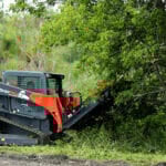 skid loader brush mower cutting down tree