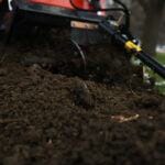 trencher auger spewing dirt