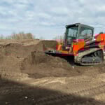 skid steer dozer blade pushing dirt