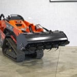 mini skid steer tiller in shop