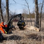 mini grapple picking up log