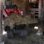 mini skid steer dirt bucket in barn