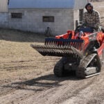 skid steer rock bucket in air