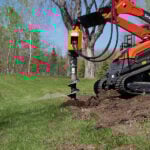skid steer mini auger in dirt
