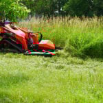 skid steer cutter in grass