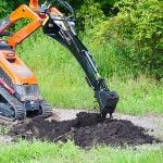 mini backhoe digging hole