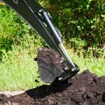 backhoe scooping dirt