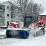 angle broom clearing parking lot