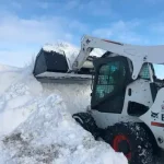 skid steer snow bucket at work