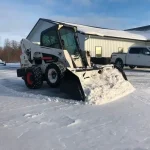 clearing parking lot with skid steer