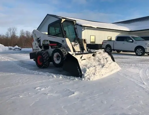 Skid Steer Snow Bucket In Field