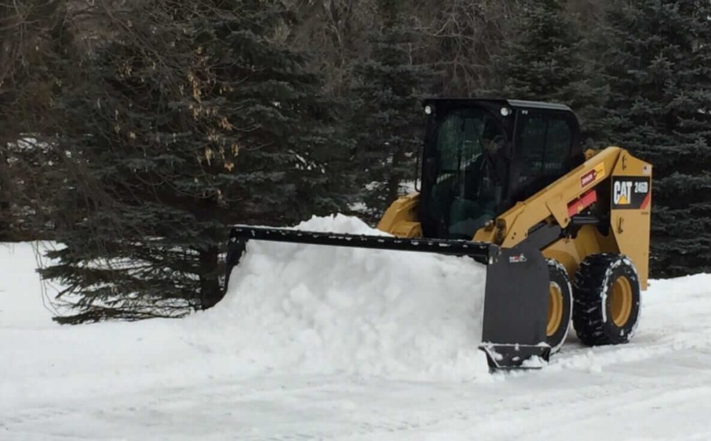 Skid Steer Snow Pusher in Field