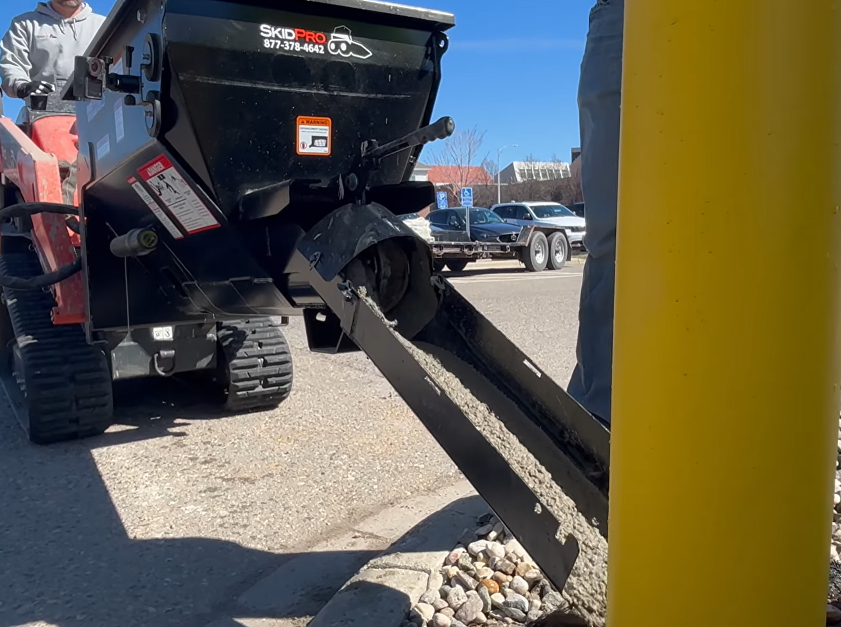 24 inch multi-link chute pouring concrete from the mini mixing bucket